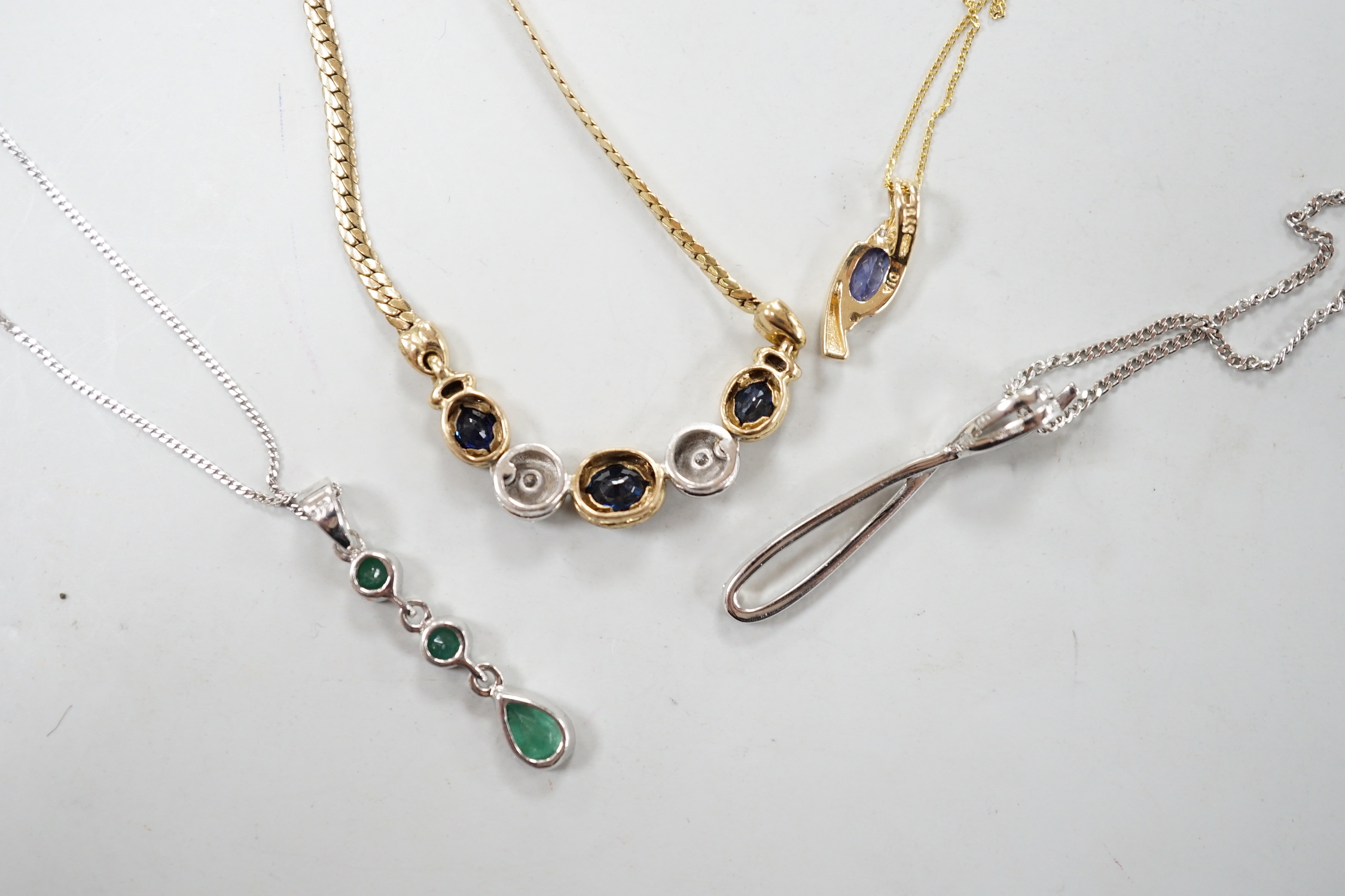 Four assorted modern 375 and gem set pendant necklaces, including white 375 and diamond chip set, 50cm and white 375 and emerald drop set, gross weight 11.3 grams.